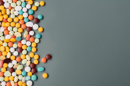 A pile of colorful pills sitting on top of a table. AI generative image . A lot of copy space.の素材