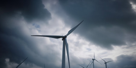 A group of wind turbines under a cloudy sky. AI generative image.の素材
