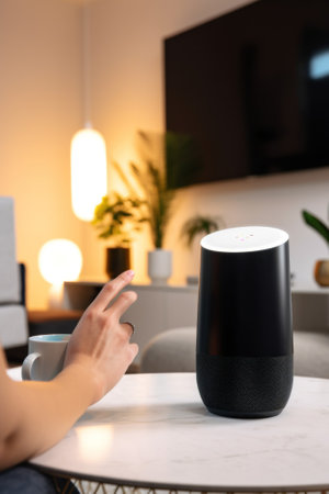 A person sitting at a table with a smart device. AI generative image.の素材