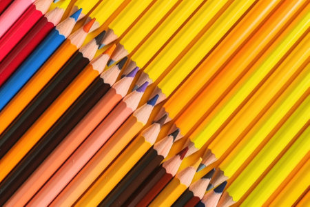 A group of colored pencils lined up in a row. AI generative image.の素材