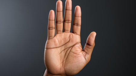 A person holding their hand up in the air. Generative AI image.の素材