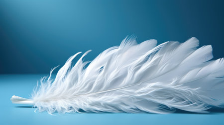 A white feather on a blue surface. Generative AI image.の素材
