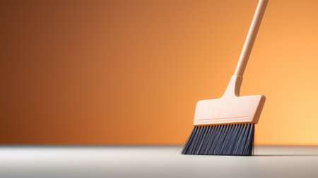 A broom with a black handle on top of an orange background, AIの素材