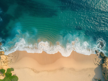 An aerial view of a beach with waves and sand, AIの素材