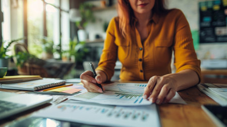 A woman sitting at a desk with papers and pen in hand, AIの素材