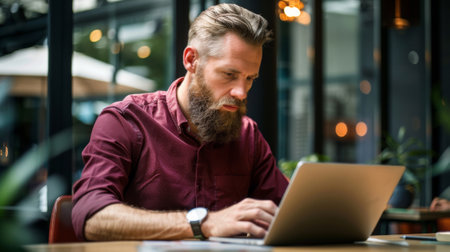 A man with a beard sitting at his laptop computer, AIの素材