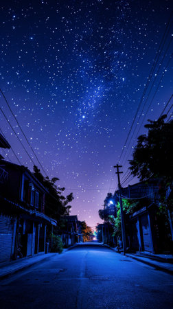 A street with power lines and houses at night under a starry sky, AIの素材