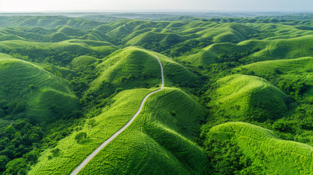 A road winding through a green landscape with mountains in the background, AIの素材