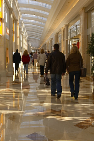 A group of people walking down a long walkway in the mall, AIの素材