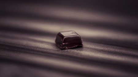 A small piece of chocolate sitting on a table top, AIの素材