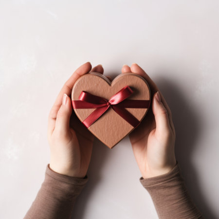 A person holding a heart shaped box with red ribbon, AIの素材