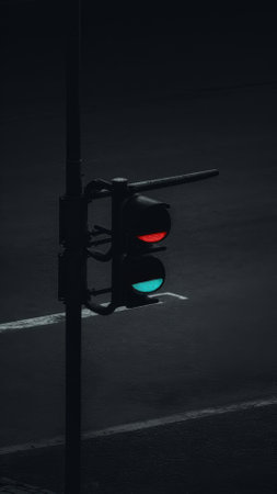 A traffic light is on at a stop sign in the dark, AIの素材