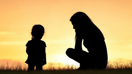 Silhouette of a woman and child at sunset, sharing a tender moment outdoors, AIの素材