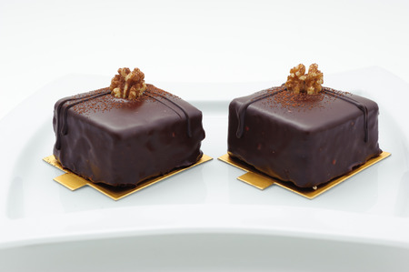 Chocolate sponge cakes on white plateの写真素材