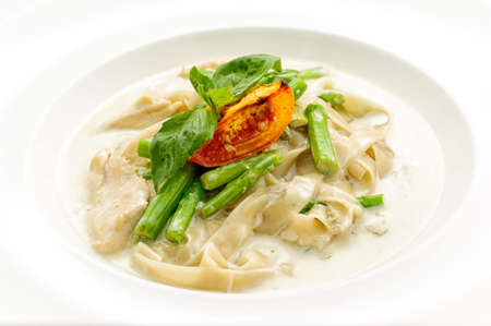 Stewed chicken with noodles on white plateの写真素材