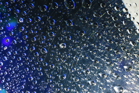Water drops on plastic surface with refracted image