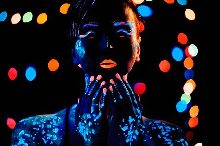 Girl with neon paint bodyart portrait, studio shot