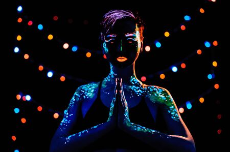 Girl with neon paint bodyart portrait, studio shot