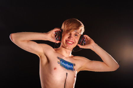 Young man with body-art as radio scale on chestの写真素材