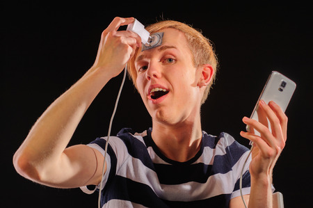 Young man with body-art and mobile phoneの写真素材