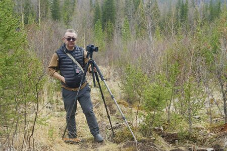 Photographer near a geyser lake in Altai