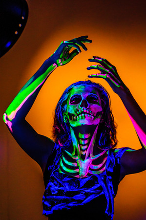 Skeleton bodyart with blacklight studio portraitの写真素材
