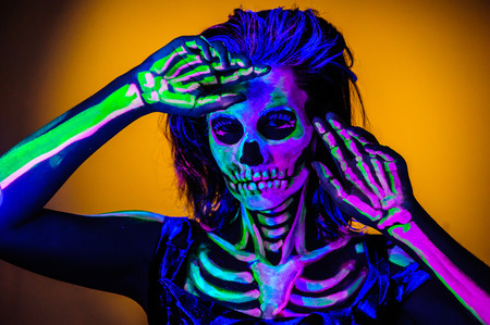 Skeleton bodyart with blacklight studio portraitの写真素材