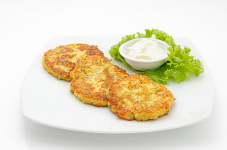 Potato cutlets with sour cream isolated on whiteの写真素材