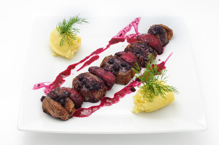 Grilled beef with cranberry sauce isolated on whiteの写真素材