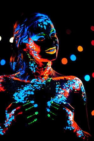 Girl with neon paint bodyart portrait, studio shotの写真素材