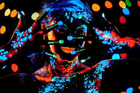 Girl with neon paint bodyart portrait, studio shotの写真素材