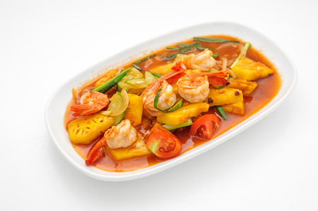 Fried shrimps with pineapple in sweet sauce isolated on whiteの写真素材