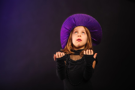Young girl at Halloween party with hat and chapletの写真素材