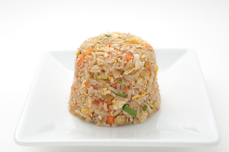Fried rice with vegetables isolated on whiteの写真素材