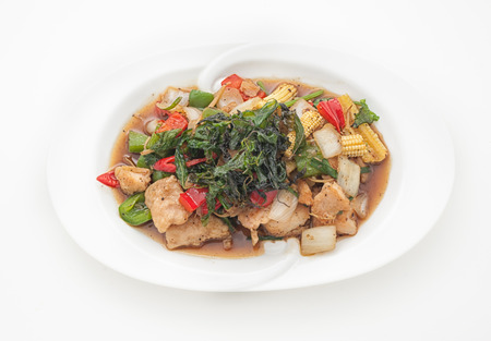 Fried fish with basil leaves isolated on whiteの写真素材