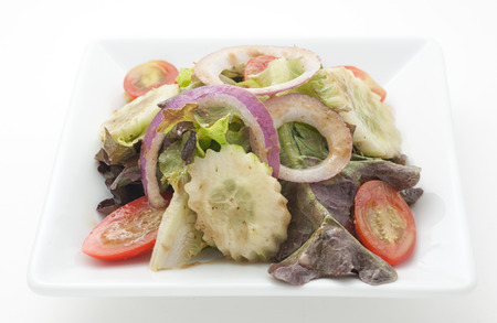 Vegetable salad isolated on whiteの写真素材