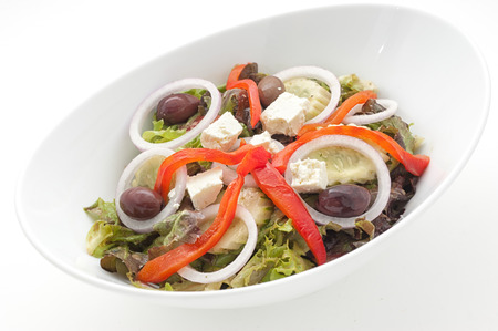 Greek salad with slices of paprika isolated on whiteの写真素材
