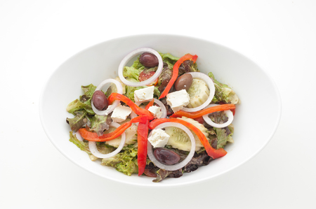 Greek salad with slices of paprika isolated on whiteの写真素材