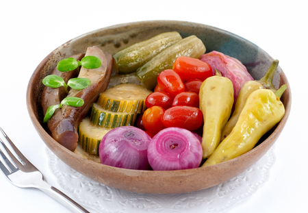 Small bowl with marinated vegetables isolated on whiteの写真素材