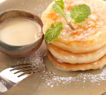 Pancaces with condenced milk isolated on whiteの写真素材