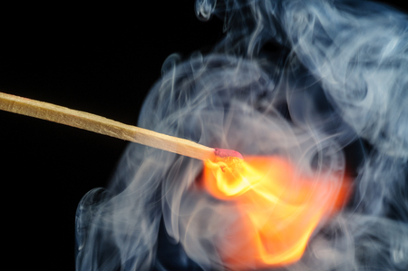 Ignited match and blown off match isolated on blackの写真素材