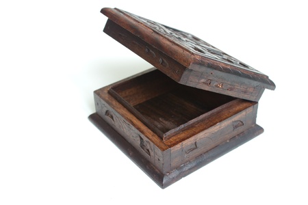 Old style carved wooden box with metal parts isolated on white background