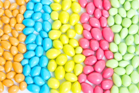 colorful sweet candies assorted spreading on white backgroundの写真素材