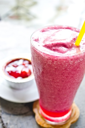 Mixed berry smoothie and strawberry pie on wooden tableの写真素材