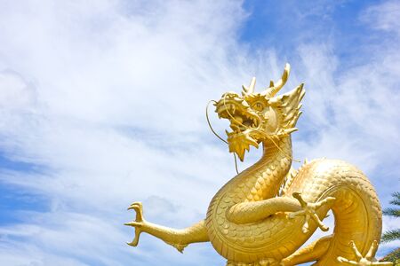 Golden dragon statue with blue sky at Phuket, Thailandの写真素材