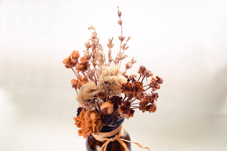 ekibany of dried wildflowers in small jar of dark glass of cinnamonの写真素材