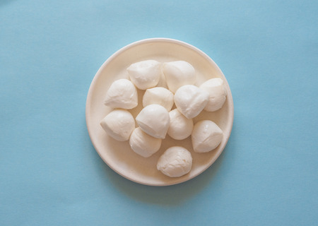 Italian mozzarella cheese on the blue background.の写真素材