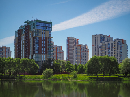 City park under blue sky with downtown skyline in the background.の写真素材
