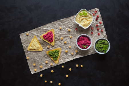 Nachos chips with hummus. Tortilla chips with guacamole, taramasalata, and hummusの写真素材
