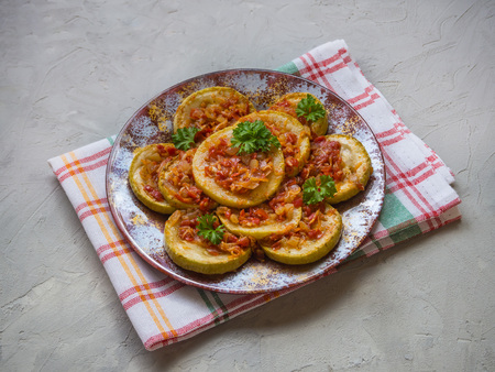 Cold snack. Zucchini fried with slices of vegetable sauce on a plateの写真素材